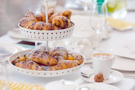 Breakfast with coffee and croissants in a basket