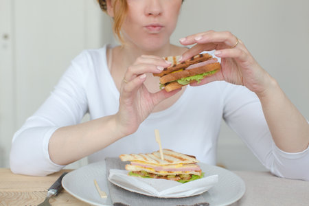 Unrecognizable woman having sandwichの写真素材