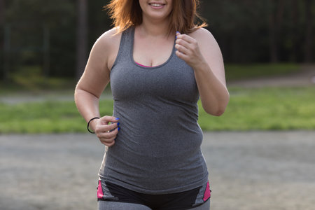 Overweight woman running. Weight loss concept.の写真素材