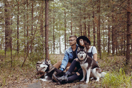 Young couple with dogs in forest
