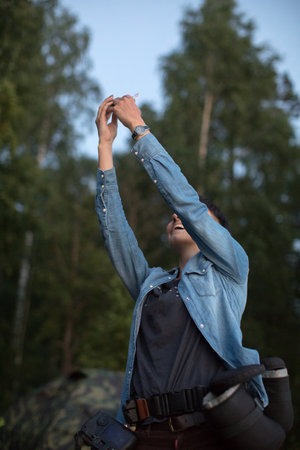 Cheerful woman taking selfie while trekking