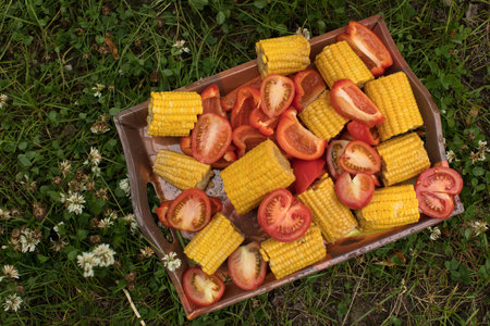 Cut corns and tomatoes in wooden box