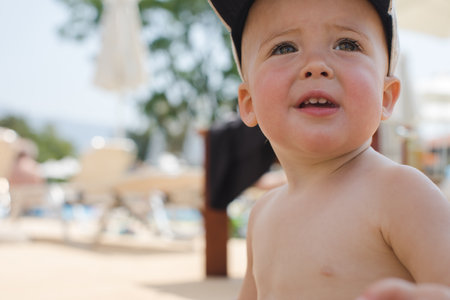 Adorable child in cap on beachの写真素材