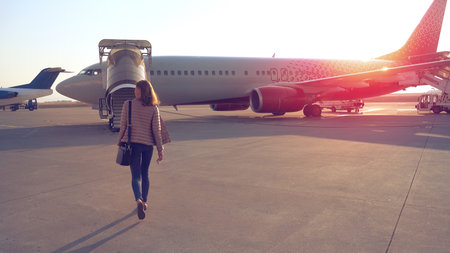 Woman going to plane an aerodromeの写真素材