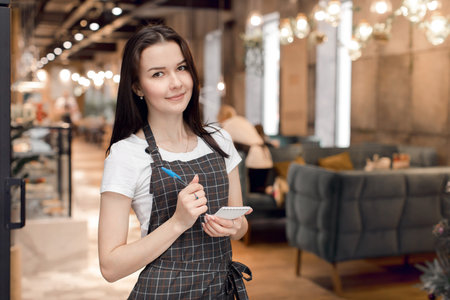 The waitress writes the order in a notepadの写真素材