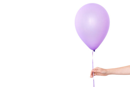 Womans hand holds balloons in a white background isolatedの写真素材