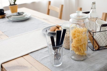 Food which rich with slow carbohydrates. Oatmeal and oat in bowls near sprigs of wheat on white wooden background top view copy spaceの写真素材