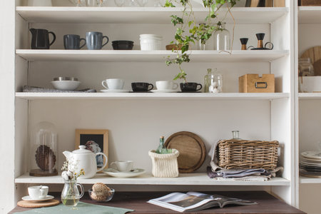 White wooden shelves with decorative elements and elegant kitchenware.の写真素材
