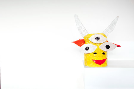 Homemade paper head of a fairy mythical creature on a white background