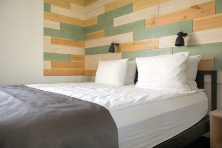 Nice soft bed standing in middle of light cozy bedroom