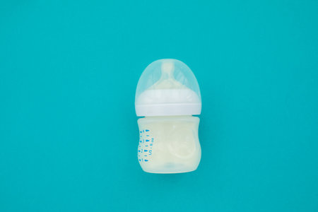 Baby bottle whith mixture milk baby feeding blue background top viewの写真素材