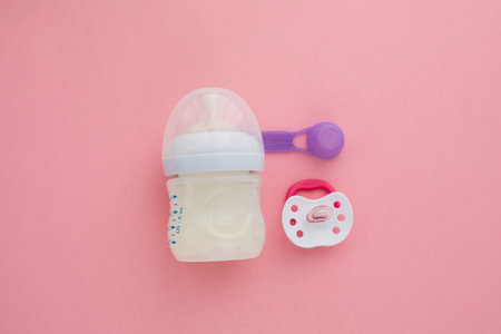 preparation of mixture baby feeding on pink background top view