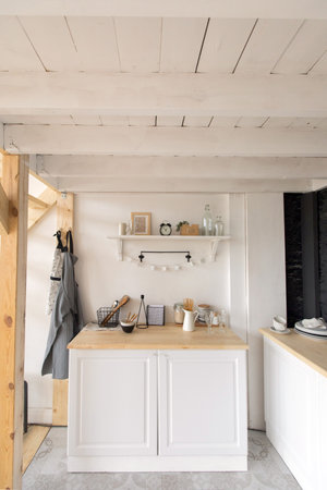 Various lovely accessories standing on shelf and cupboard in cozy kitchenの写真素材