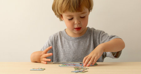 Little boy playing with puzzle, early education conceptの写真素材