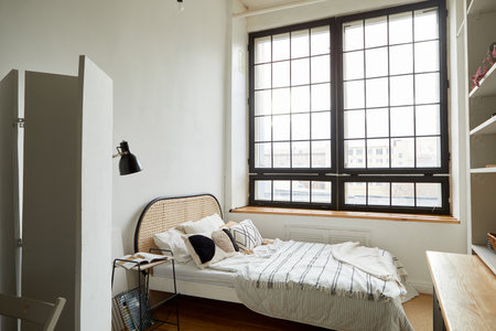 Light bedroom in modern apartment in minimal styleの写真素材