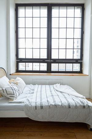 Light bedroom in modern apartment in minimal styleの写真素材