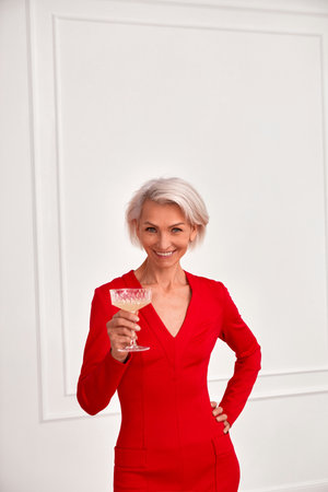 Content mature woman with glass of champagneの写真素材