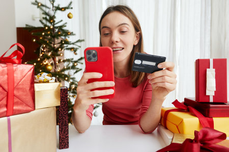 Woman making payment online before Christmas celebration