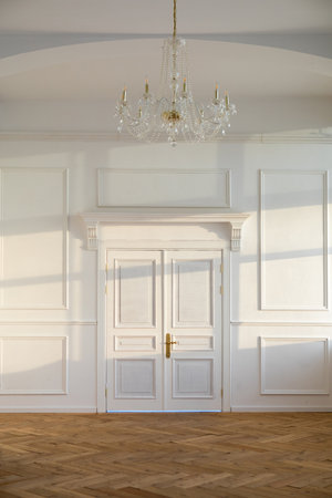 Spacious white classic room with closed doors