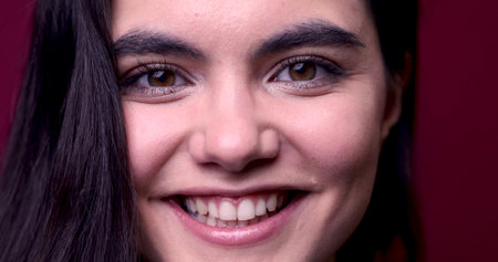 Smiling young woman face close upの写真素材