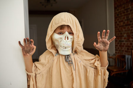 Kid in Halloween costume looking at cameraの写真素材