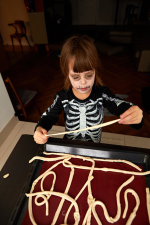 Boy child in skeleton costume preparing for halloween holidayの写真素材