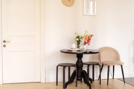 Flowers and magazine near dishware on tableの写真素材