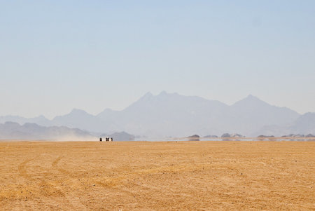 mirage in egypt rocky desert with mountains silhouetteの写真素材