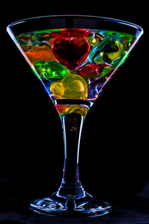 photo of a glass of the martini decorated with multi-colored heartsの写真素材