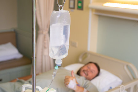 Close-up. Male hand with a dropper during chemotherapy in a hospital. The man is in the hospital...