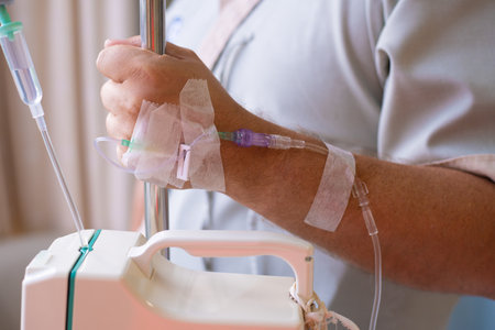 Close-up. Male hand with a dropper during chemotherapy in a hospital. Hand with a dropper. Health is a topic of health and healingの写真素材