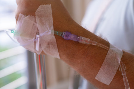 Close-up. Male hand with a dropper during chemotherapy in a hospital. Hand with a dropper. Health is a topic of health and healingの写真素材