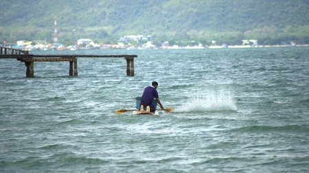 Fisherman of lake in action when fishing on twilight, Thailand.の写真素材