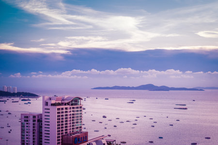 lot of ship or boat on the sea ocean of Pattaya bay and city in Thailand. At Sunsetの写真素材