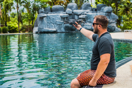 a man launches a drone for flight, with which you can take photos and video filmingの写真素材