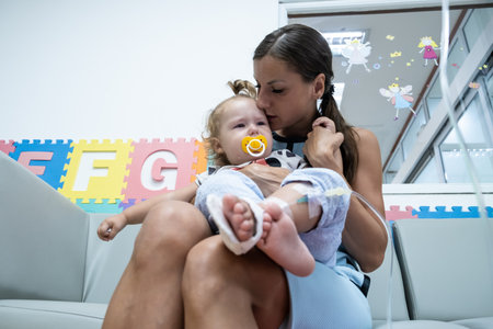 mom and crying little daughter in the hospital. Little girl is injected.の写真素材