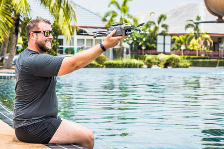 a man launches a drone for flight, with which you can take photos and video filmingの写真素材