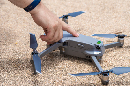 Male hand presses the button to launch the drone for flight, close-upの写真素材