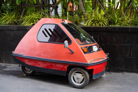Inplatnet red three-wheeled light car on the street of Pattaya Thailand.の写真素材