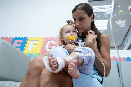 mom and crying little daughter in the hospital. Little girl is injected.の写真素材