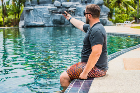 a man launches a drone for flight, with which you can take photos and video filmingの写真素材