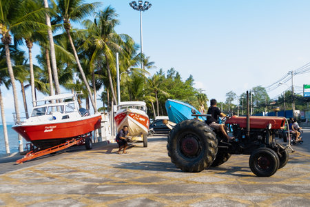 Pattaya, Thailand - May 28, 2019: Boat yard Thailand. Boats loaded onto a tractor for transportation.のeditorial素材