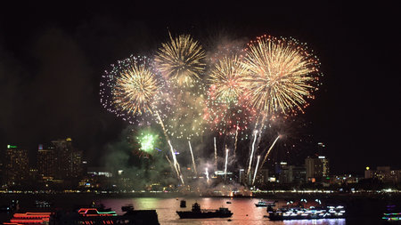Flying during the festival of fireworks in the bay with shipsの写真素材