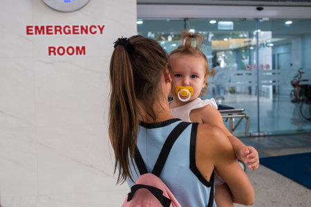 Mom and child come in in the emergency room at the emergency room in Hospitalの写真素材