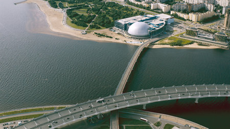 A smooth aerial flight, a flight over a bridge standing over a river on which cars ride. 4k.の写真素材