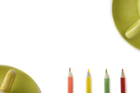 colored pencils, calculator key and part of a mug on an isolated white background. Copy space.の写真素材
