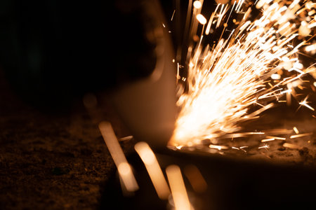 Many sparks from a work saw at nightの写真素材