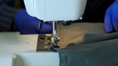 Close-up of sewing machine needle rapidly moves up and down.
