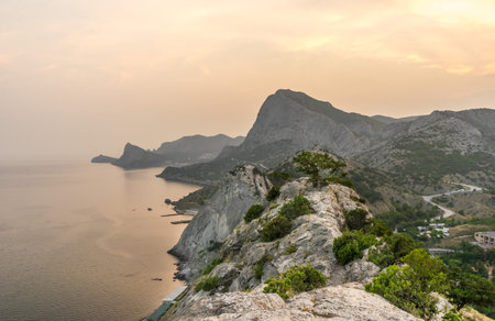 Beautiful mountain and sea landscape from the old Genoese fortress in Sudak in Crimea at sunsetの写真素材