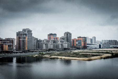 Modern residential buildings on the banks of the river Kazanka. Urban High Contrast Desaturated Look. Cross processed photoの写真素材